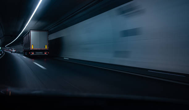istock Cars on a highway going through a long modern tunnel 1167215544