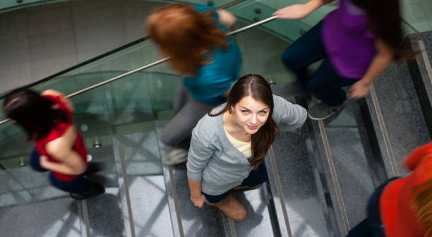 istock Students rushing up and down a busy stairway 1167215664