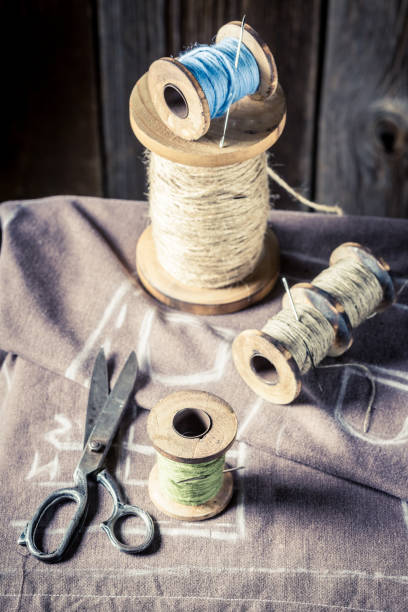 istock Closeup of sewing table with scissors, cloth and threads 1167215670