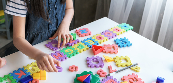 Kids playing with puzzle, learning concept