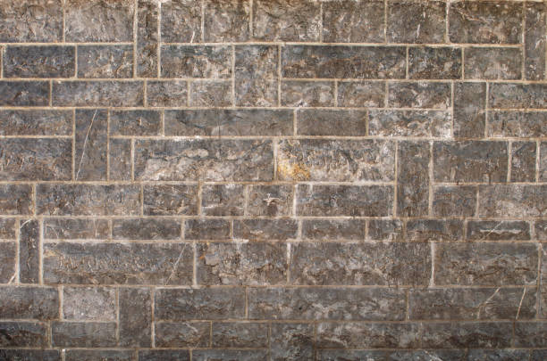 textura gris de piedra de mármol áspero - retaining wall fortified wall surrounding wall stone wall fotografías e imágenes de stock