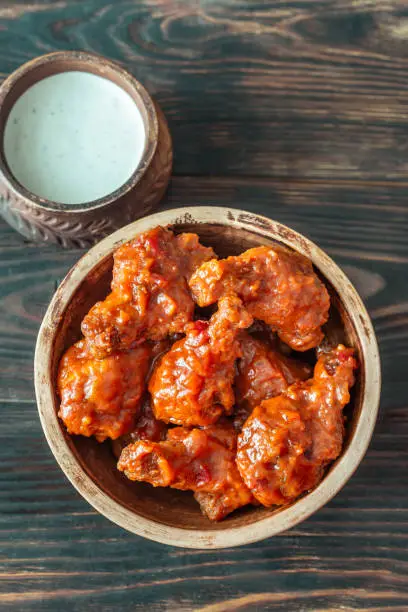 Bowl of buffalo wings with blue cheese dip: top view