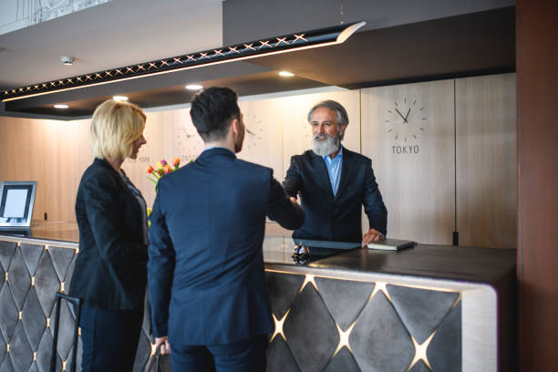 istock Mature Hotel Receptionist Shaking Hands with Male Guest 1167221184