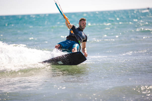 istock Kitesurfing. Man rides on kite on waves 1167223263