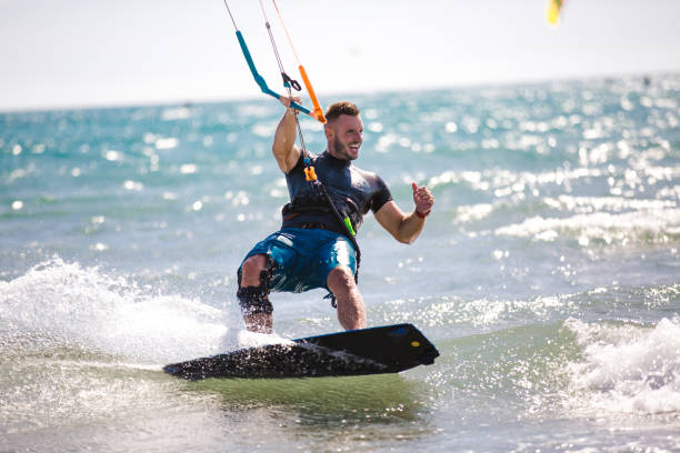 istock Kitesurfing. Man rides on kite on waves 1167224190