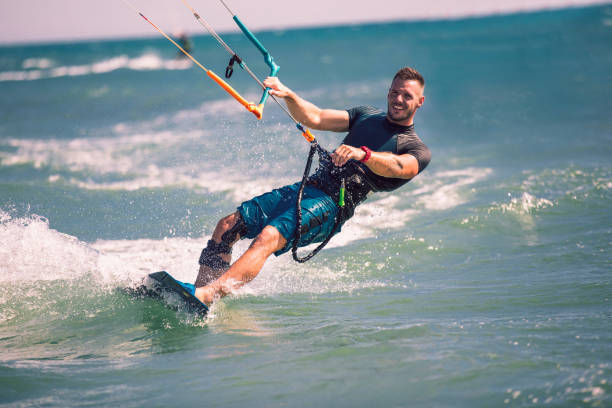 istock Kitesurfing. Man rides on kite on waves 1167224287