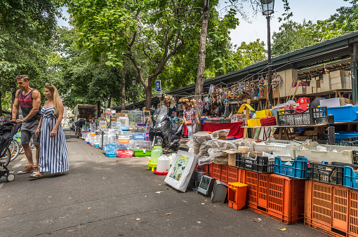 Paris, France - August 3, 2019: Tourists and locals visiting the bird market in the Louis Lépine square, Paris France. In this place you will find birds of all colors and species: canaries, budgies, lovebirds, and even some fish and rodents.