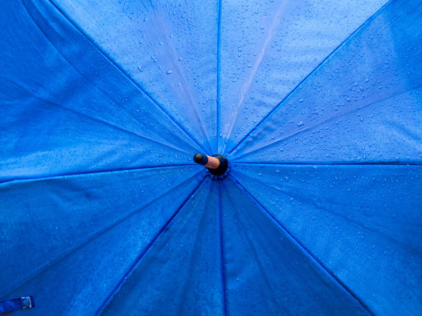 istock Close Up of Raindrops on  Blue Umbrella 1167225316