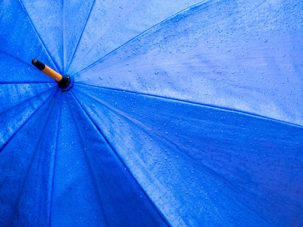 istock Close Up of Raindrops on  Blue Umbrella 1167226971