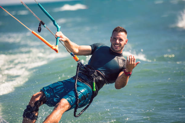 istock Kitesurfing. Man rides on kite on waves 1167227057