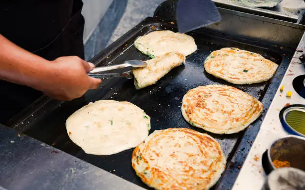 Close up on egg pancakes preparation at a vendor stalls
