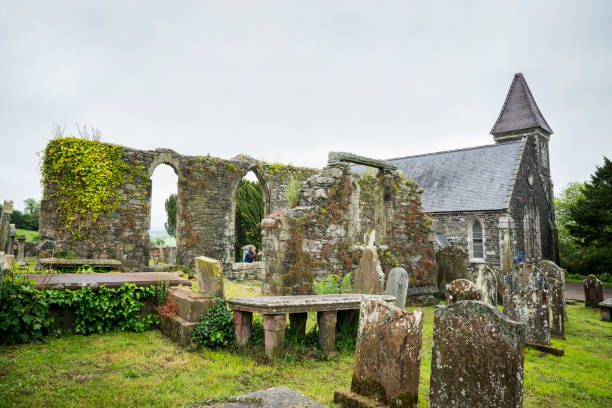 Wigtown Parish church, a granite stone structure built in 1858, sits among tombstones from an ancient cemetery with ruins from an earlier church built in 1730, Wigtown, Scotland, UK, Europe