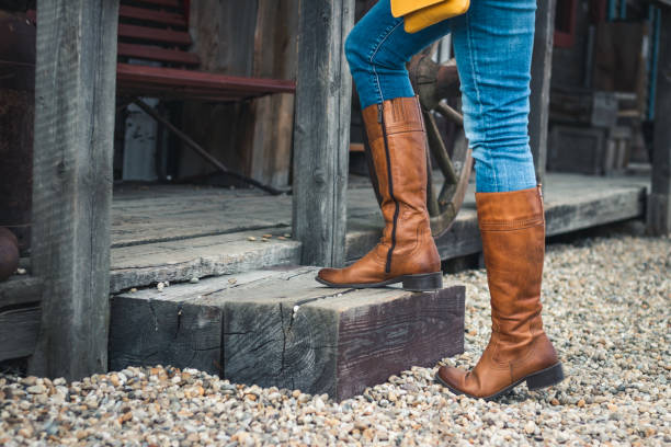 istock Female legs wearing riding boot and jeans 1167233422