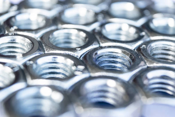 istock Metal nuts in a row background. Chromed screw nuts isolated. Steel nuts pattern. Set of Nuts and bolts. Tools for work. 1167237515