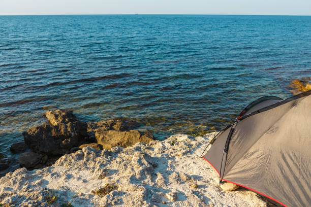istock The tent stands on a rocky seashore 1167237619