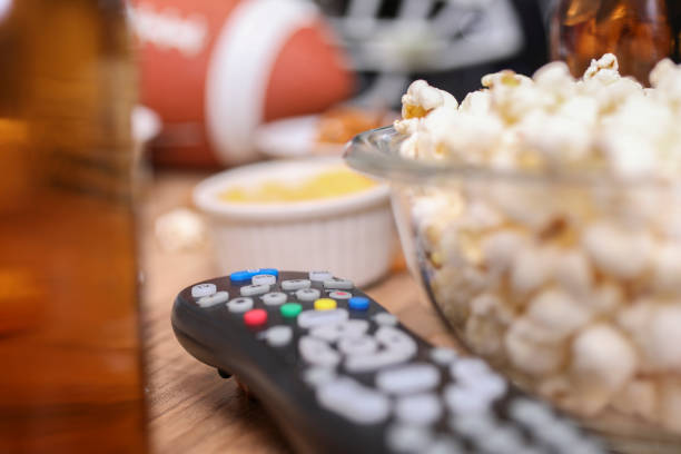 istock Watching the football game with snacks, drinks. 1167239927