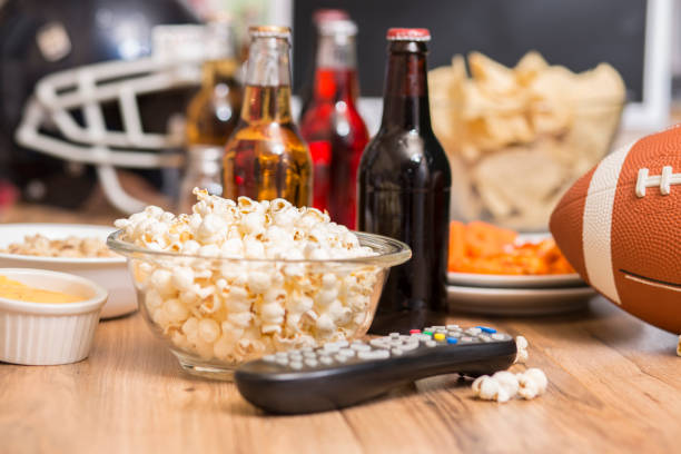 istock Watching the football game with snacks, drinks. 1167240875