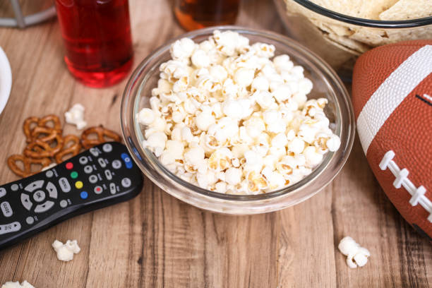 istock Watching the football game with snacks, drinks. 1167241429