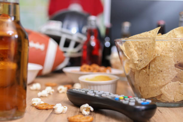 istock Watching the football game with snacks, drinks. 1167241529