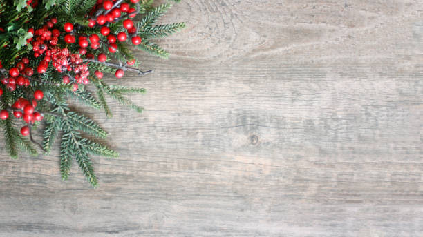 Holiday Christmas Pine Evergreen Branches and Berries Over Wood Holiday Christmas Pine Evergreen Branches and Berries Over Wood, Widescreen farmhouse photos stock pictures, royalty-free photos & images
