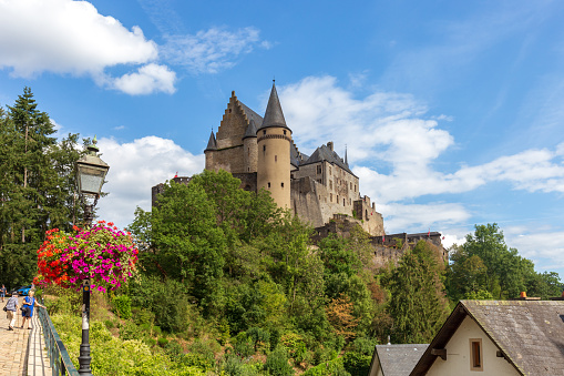 Vianden, Luxembourg - August 8, 2019: People walking on the path towards Vianden Castle, Luxembourg, one of the largest and finest feudal residences of the Roman and Gothic eras in Europe.