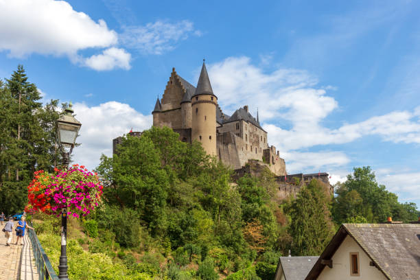 People walk on the path to the castle of Vianden, Luxembourg. Vianden, Luxembourg - August 8, 2019: People walking on the path towards Vianden Castle, Luxembourg, one of the largest and finest feudal residences of the Roman and Gothic eras in Europe. vianden stock pictures, royalty-free photos & images
