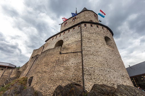 Vianden, Luxembourg - August 8, 2019: Flags at Vianden tower medieval ruin of Vianden in Luxembourg.