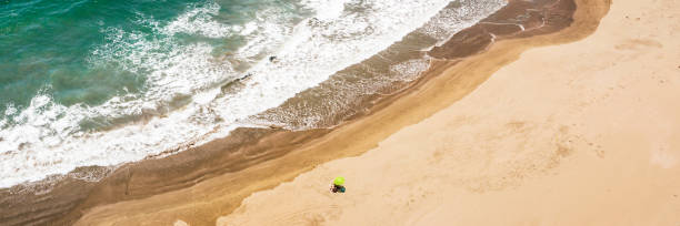 istock Sandy beach with a yellow umbrella in Huarmey, Peru 1167254417