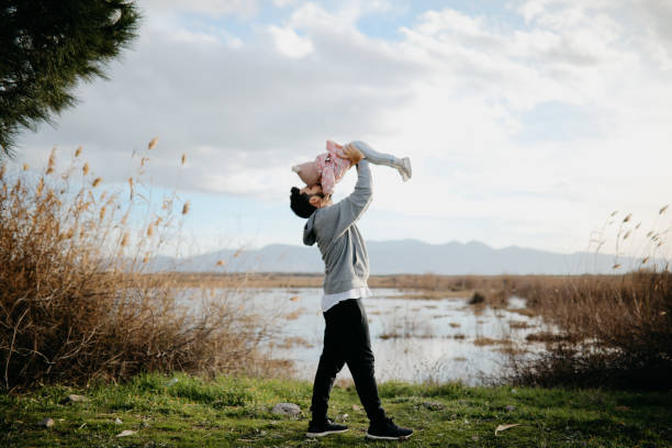 istock Father throws daughter in the air 1167254864