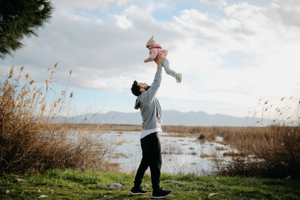 istock Father throws daughter in the air 1167256153