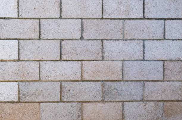 istock Old white and tan layered concrete brick wall texture. 1167262442