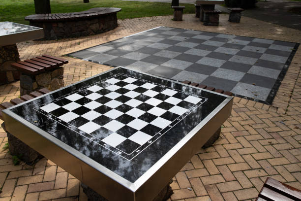 istock A small chess table in the park. Empty board game table. Summer season. 1167262574