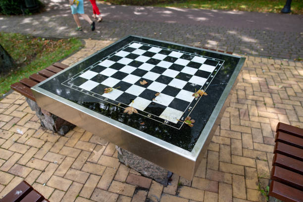 istock A small chess table in the park. Empty board game table. Summer season. 1167262802