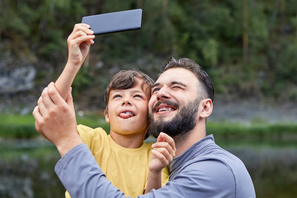 istock Dad and son take pictures together on fathers day. 1167266970