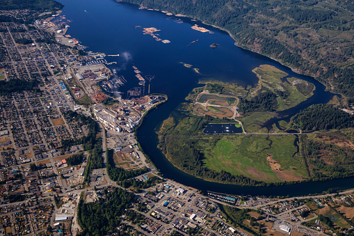 Aerial view of a small industrial town, Port Alberni, on Vancouver Island during a sunny summer morning. Located in British Columbia, Canada.