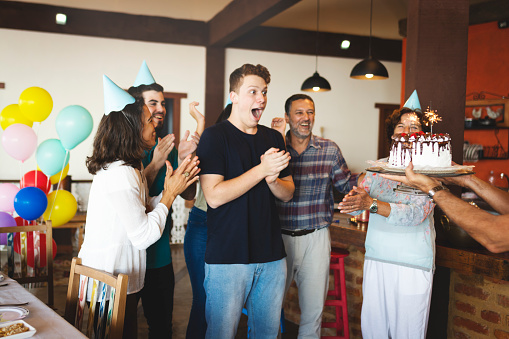 Family together preparing a surprise birthday party