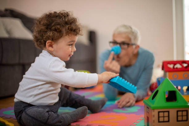 istock Grandmother playing with her grandson 1167268040