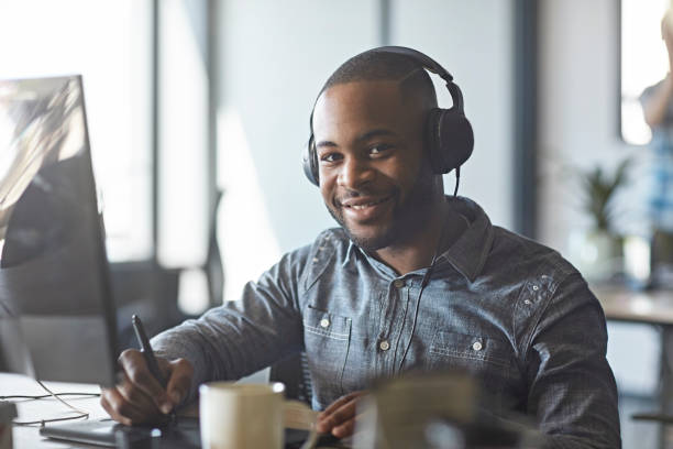 istock Young South African Man Listening to Music While Working 1167270276