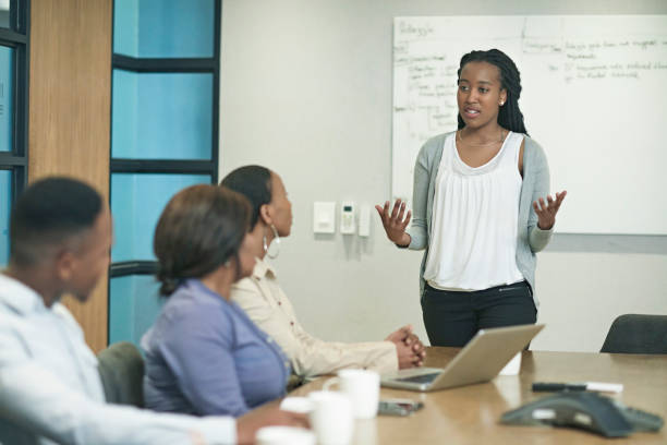 istock Young South African Businesswoman Explaining Ideas to Group 1167270316