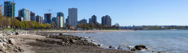 English Bay in Vancouver Downtown Vancouver, British Columbia, Canada - April 20, 2019: Panoramic view of English Bay in Stanley Park during a sunny day. beach english bay vancouver skyline stock pictures, royalty-free photos & images