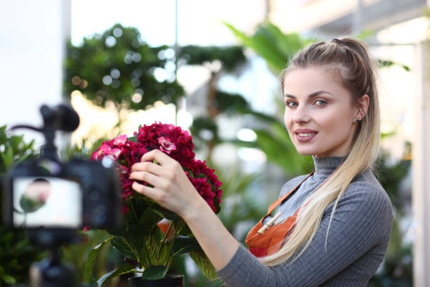 istock Young Vlogger Touching Red Hortensia to Camcorder 1167277533