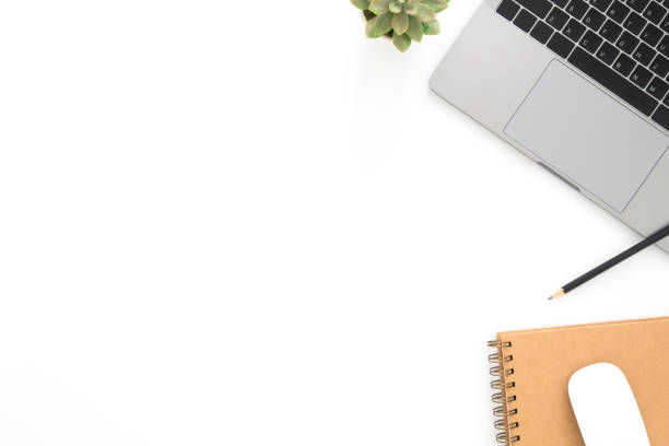 istock Creative flat lay photo of workspace desk. Top view office desk with laptop, pencil, notebook and plant on white color background. Top view with copy space, flat lay photography. 1167277701