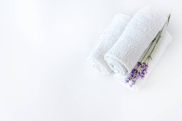 istock white clean towels and lavender flowers on white isolated background 1167278401