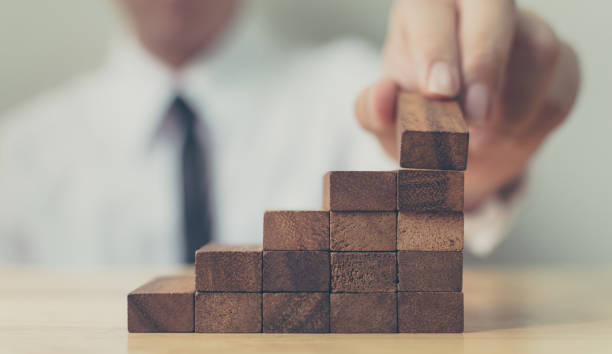 istock Hand arranging wood block stacking as step stair. Ladder career path concept for business growth success process, Copy space 1167286578