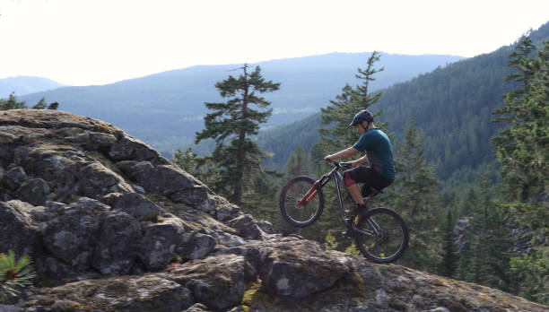 istock Mountain biker heads uphill over slab in the forest 1167294528
