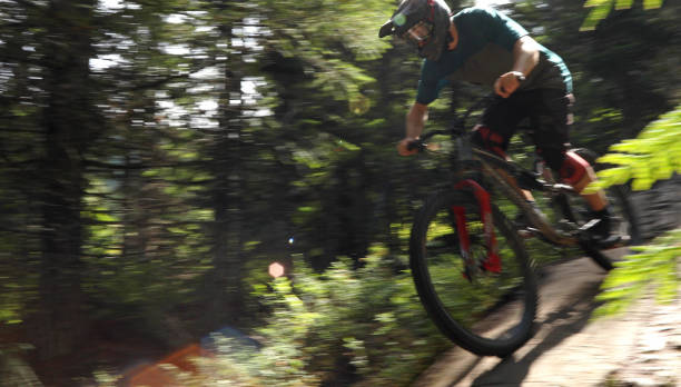 istock Male mountain biker descends steep slab through forest 1167295194