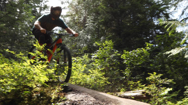 istock Male mountain biker descends steep slab through forest 1167295292