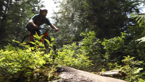 istock Male mountain biker descends steep slab through forest 1167295312