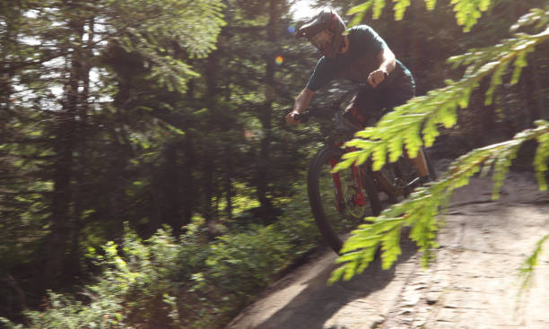 istock Male mountain biker descends steep slab through forest 1167295335