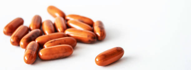 orange pills ona white background laying there